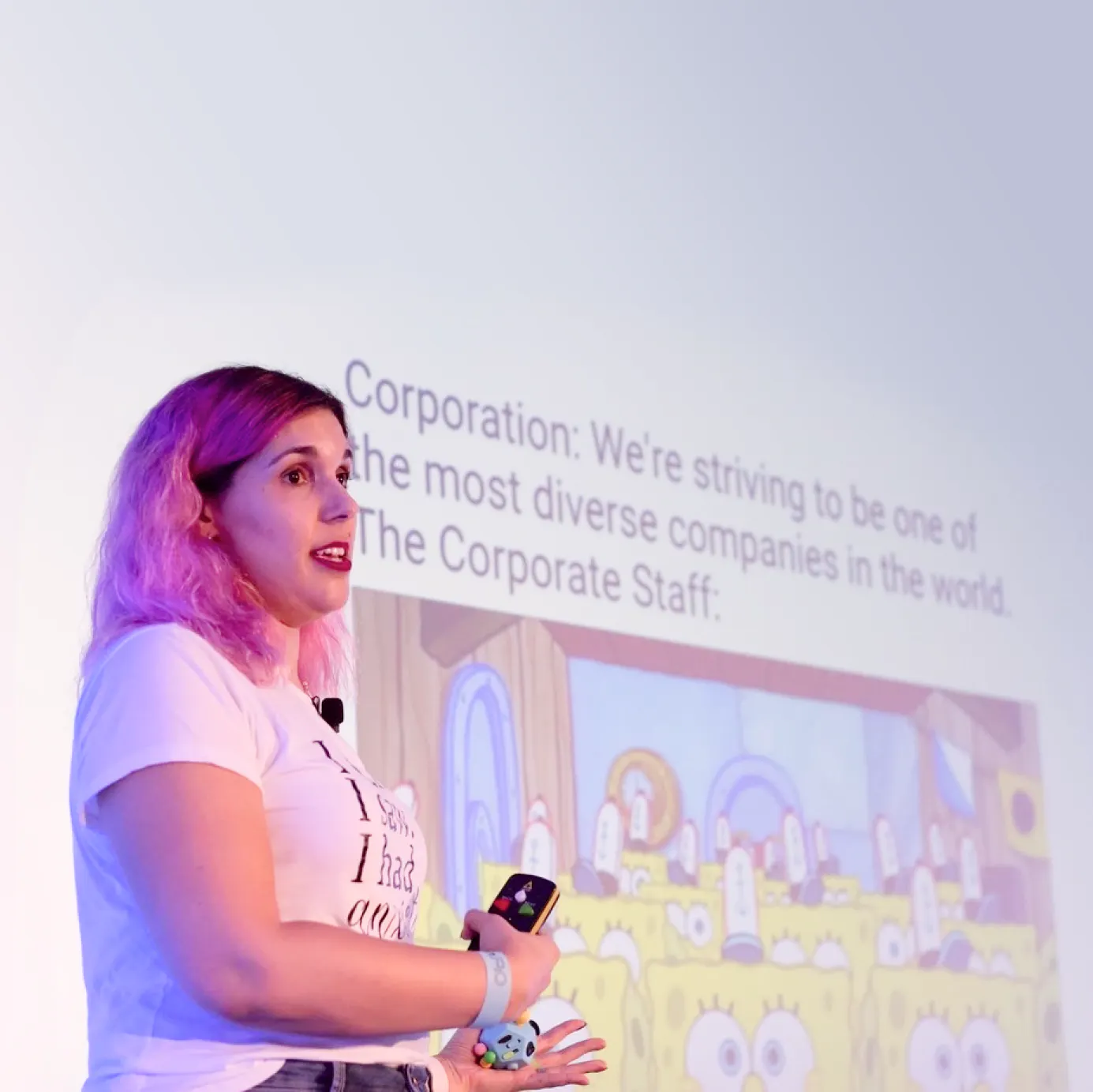 Benny at a conference with a slide about diversity behind her